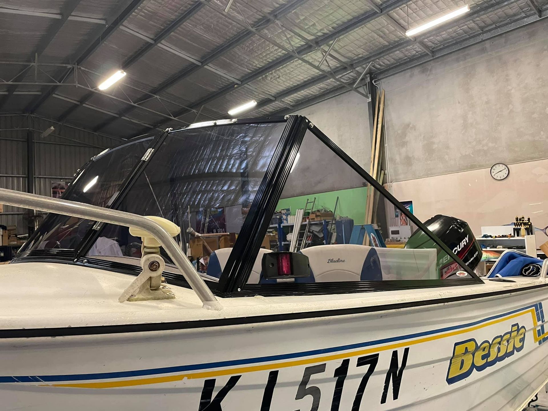 A boat with the number 517n on the side is sitting in a warehouse.