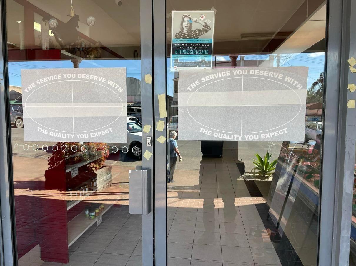 A glass door with a white sign on it - Plastiglass Mid North Coast, NSW