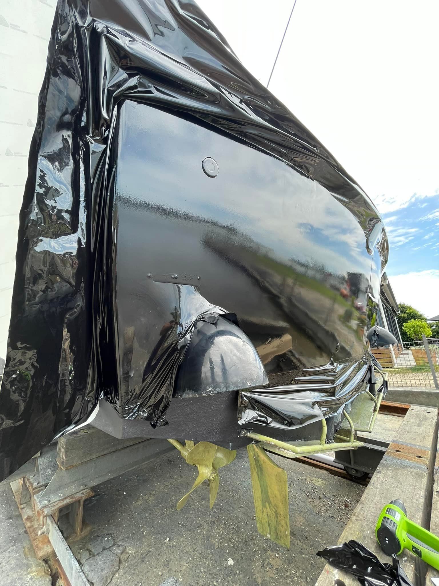 A black car is getting wrapped - Plastiglass Nabiac, NSW