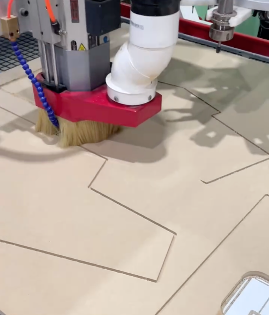 A machine is cutting a piece of wood with a brush attached to it - Plastiglass Mid North Coast, NSW