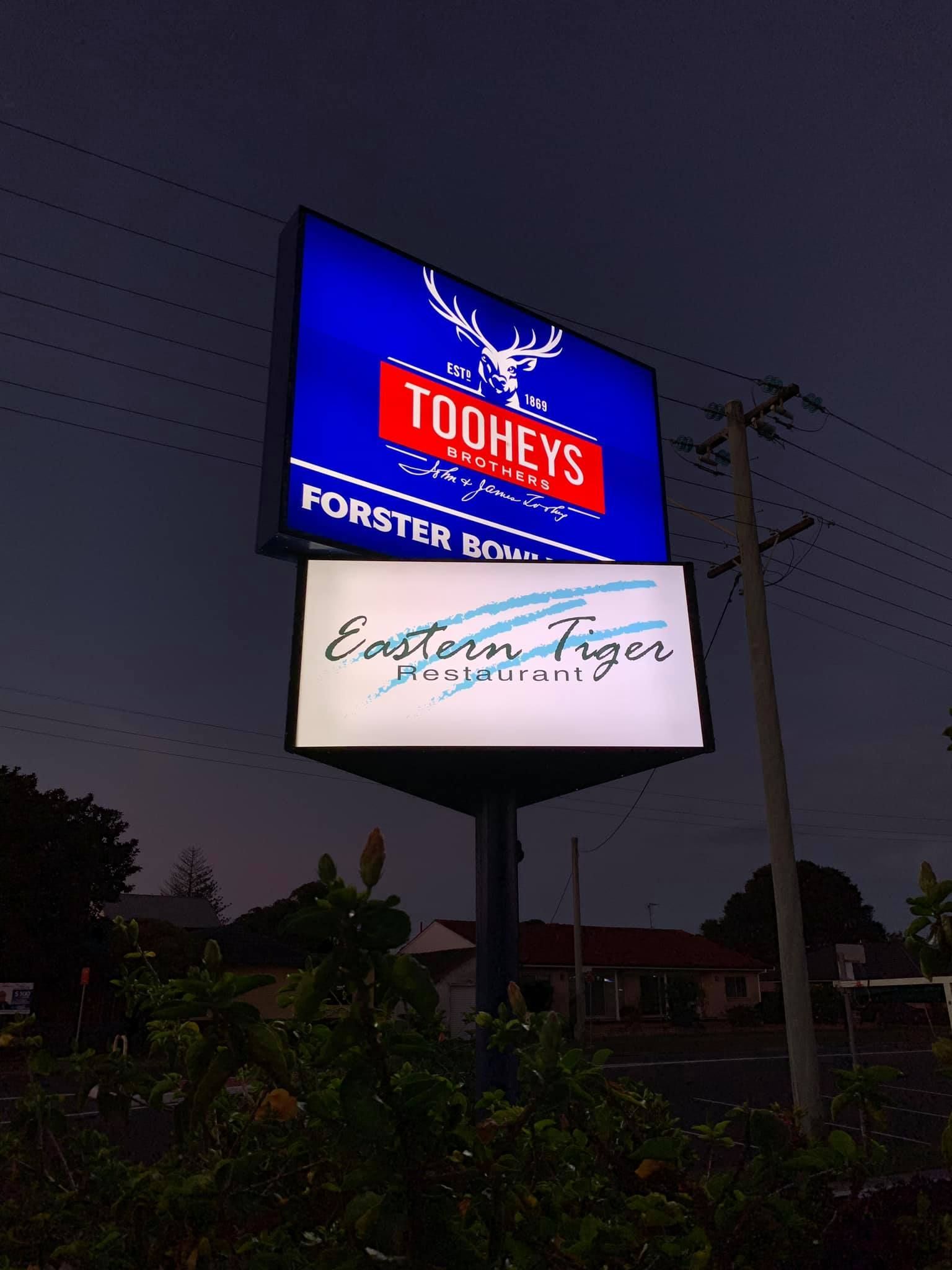 A sign for toohey's forster is lit up at night - Plastiglass Mid North Coast, NSW