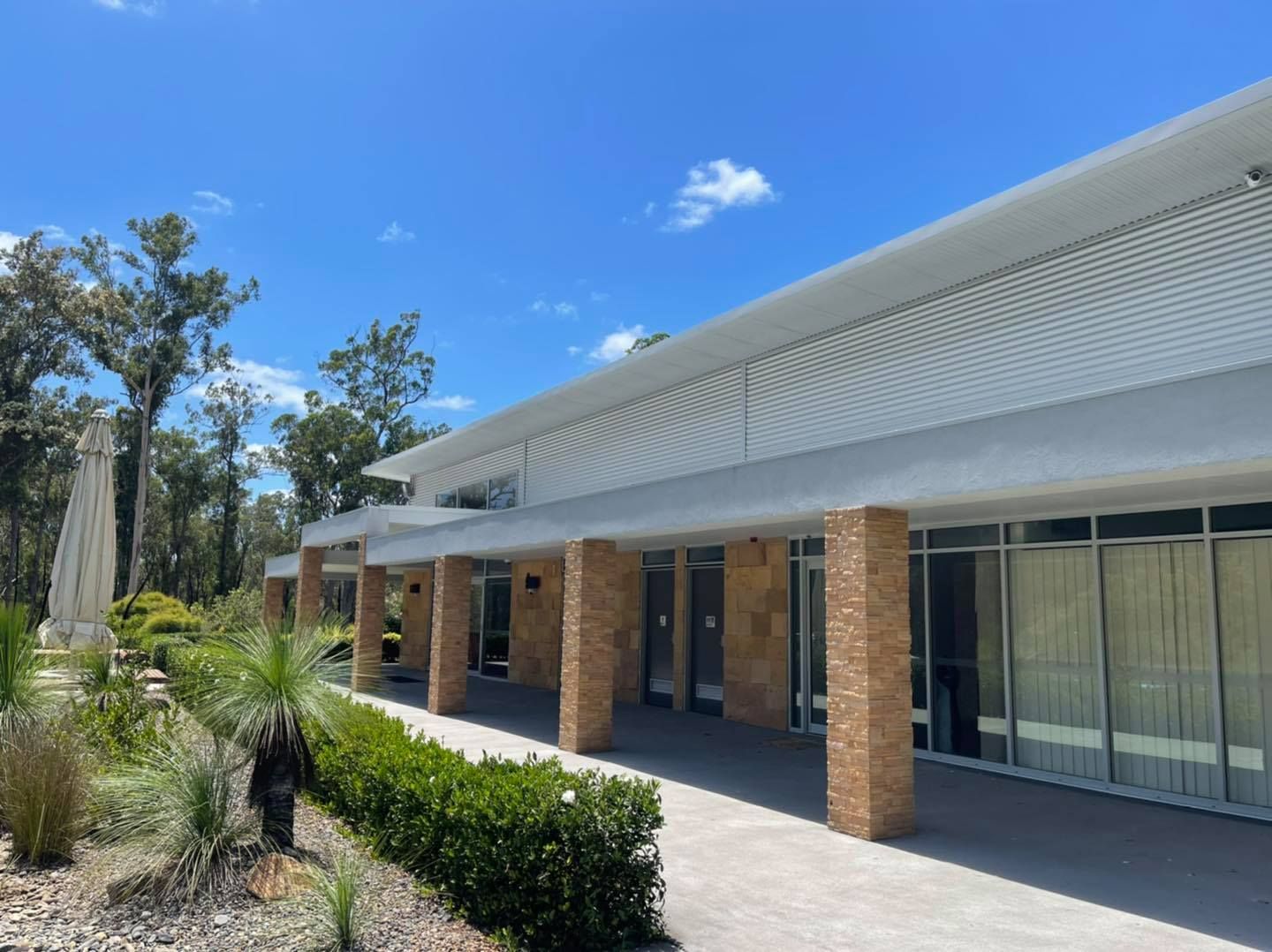 A Large Building With A Lot Of Windows And Brick Columns — United Funeral Care In Kempsey, NSW