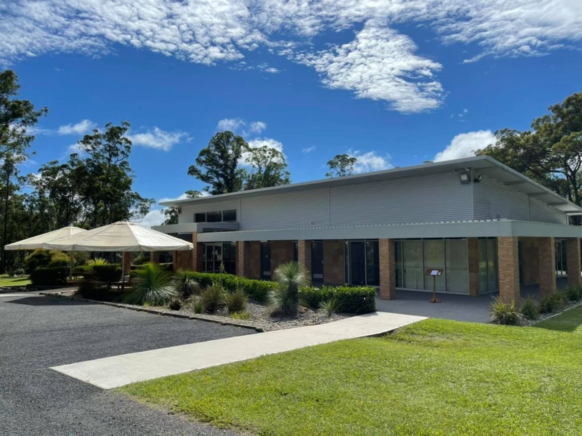 A Large House With A Lot Of Windows And A Lot Of Grass In Front Of It — United Funeral Care In Kempsey, NSW