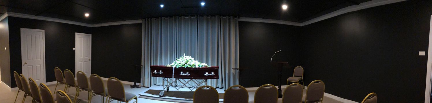 A Large Room With Rows Of Chairs And A Coffin In The Middle — United Funeral Care In Kempsey, NSW 