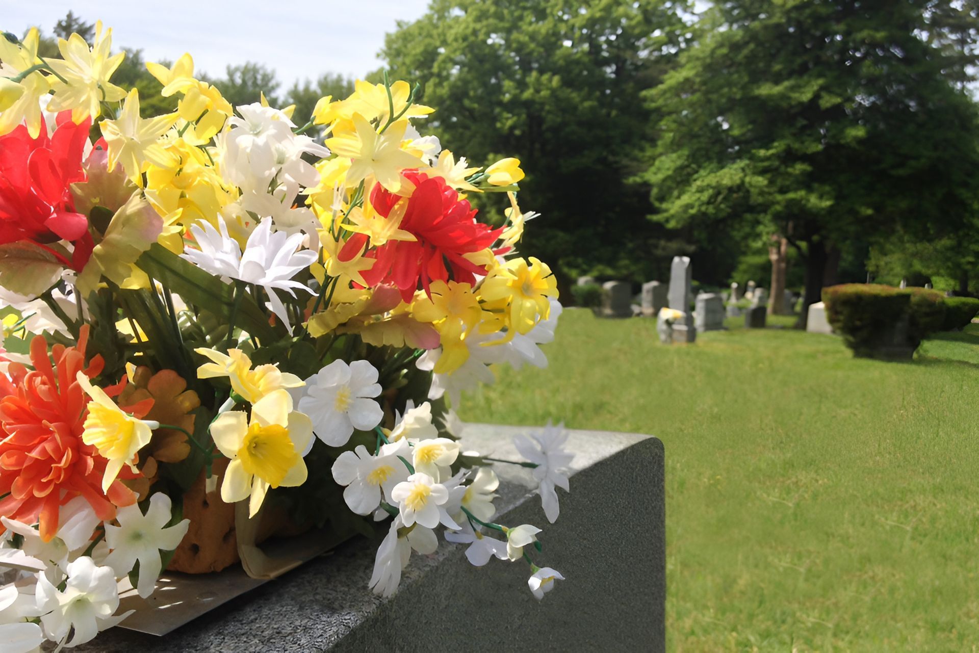 A Bunch Of Flowers Are On A Grave In A Cemetery — United Funeral Care In Crescent Head, NSW