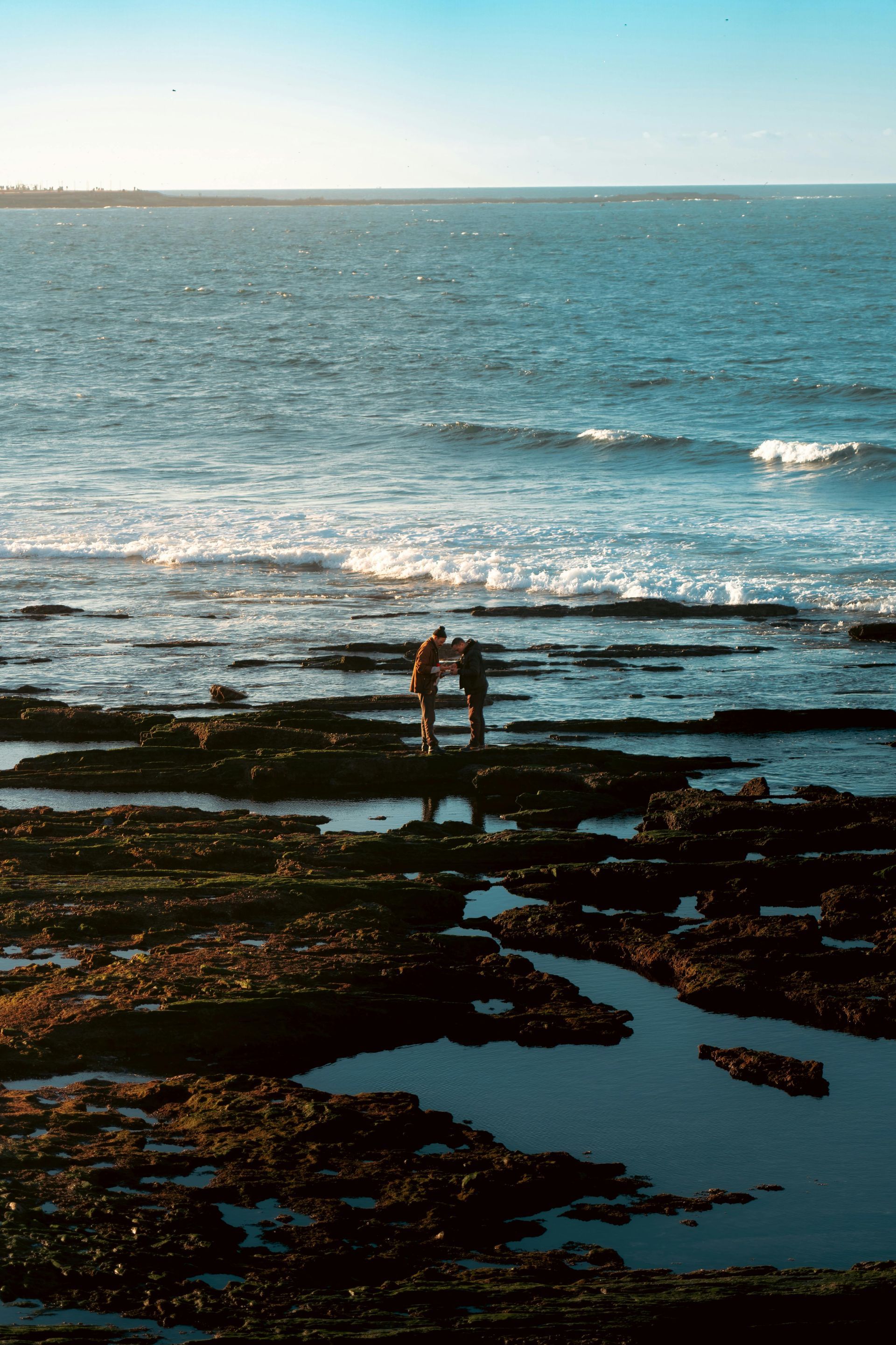 Two people Standing On The Rocks At The Beach — United Funeral Care In Kempsey, NSW