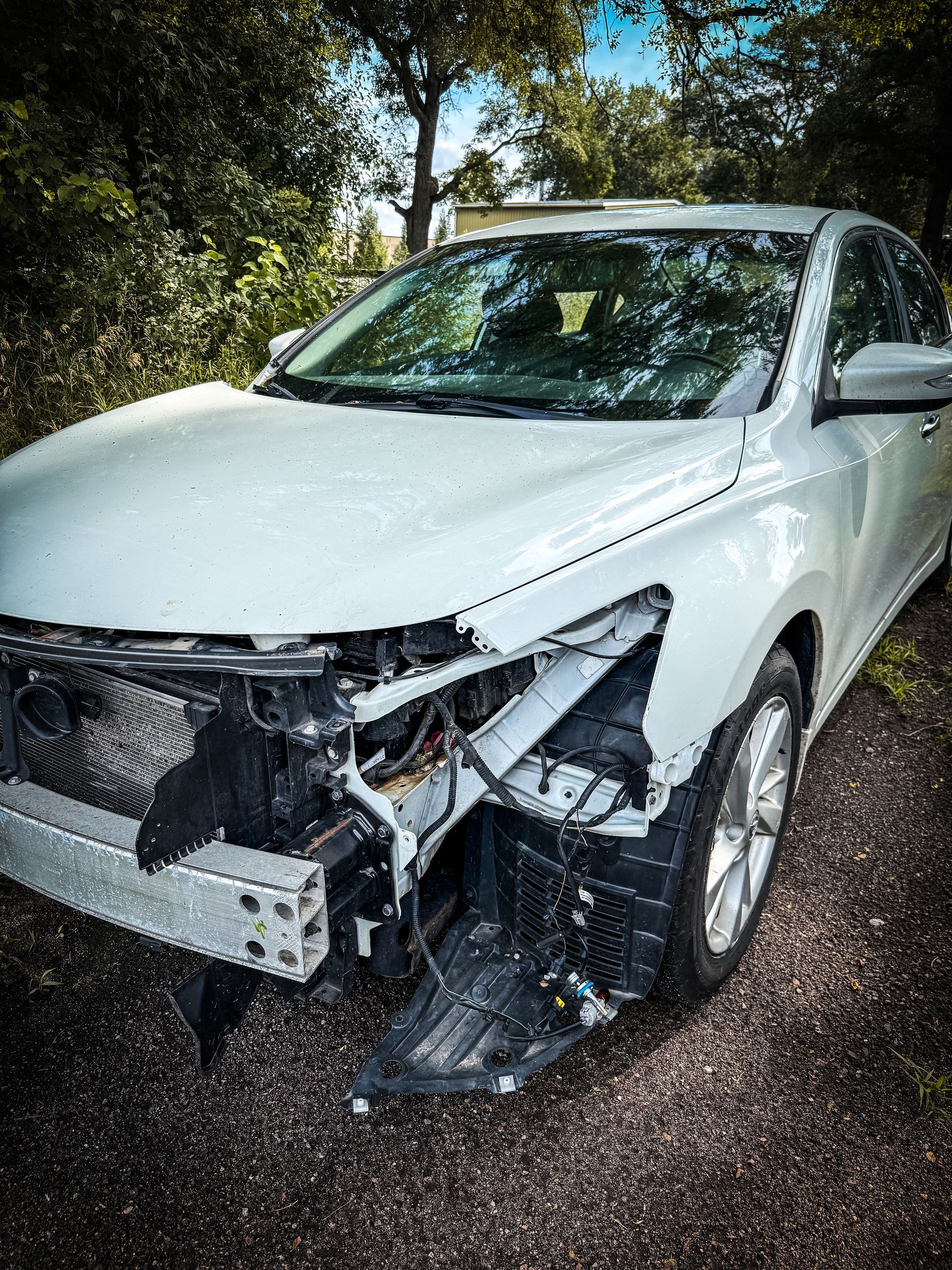 A blue pickup truck is parked on the side of the road.