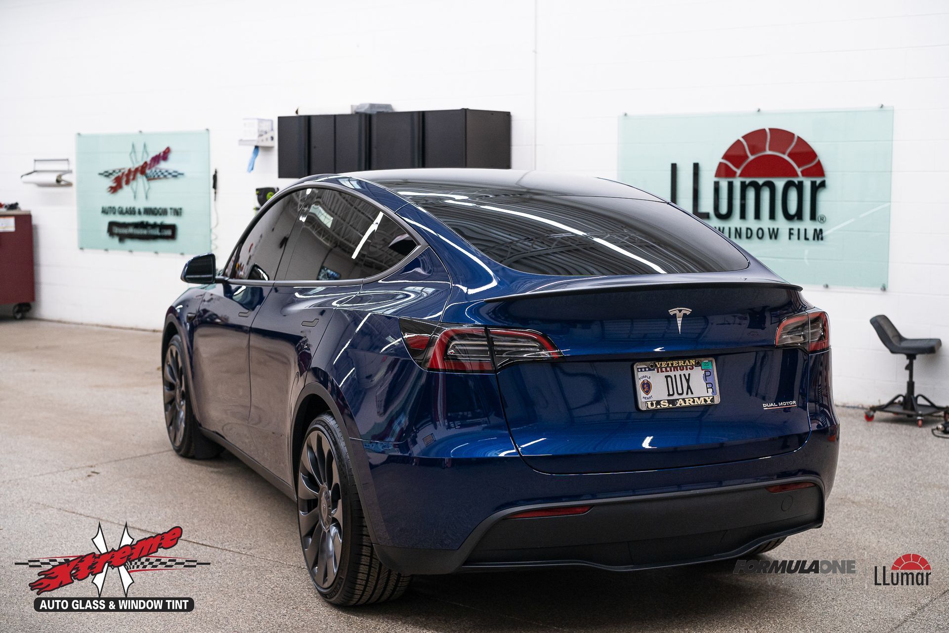 Black car with tinted windows in a shop, with a 