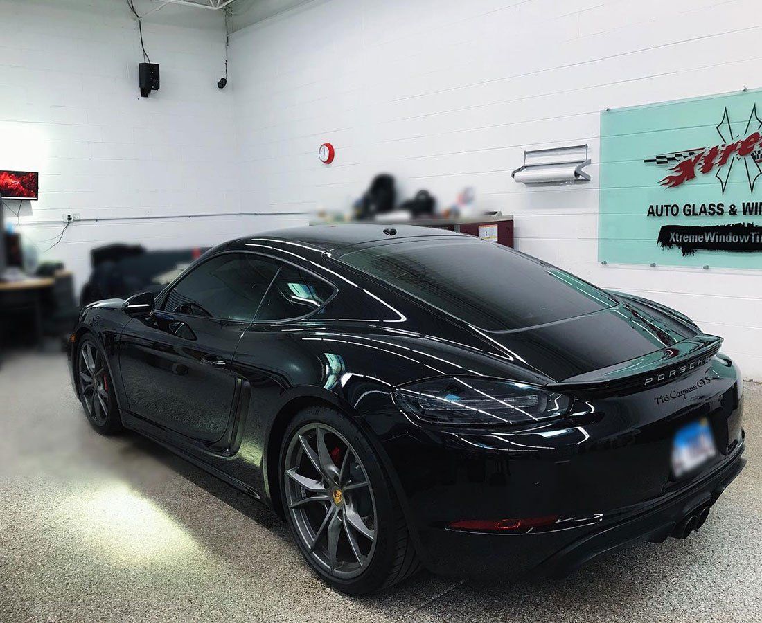 a black sports car is parked in a garage