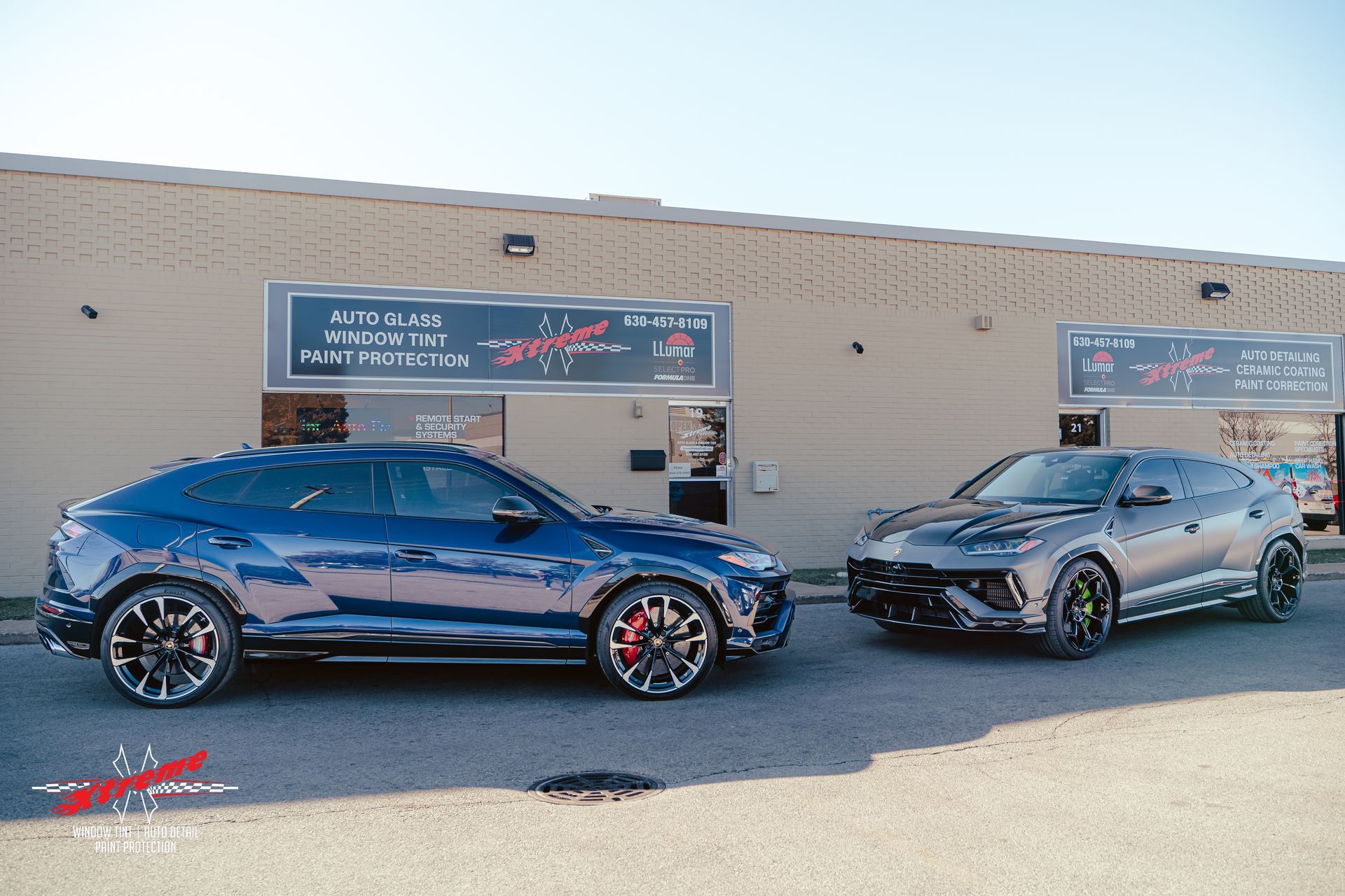 Two cars are parked in front of a building.