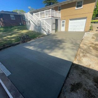 A Concrete Driveway In Front Of A House — Evansville, IN — Red Beaver Construction