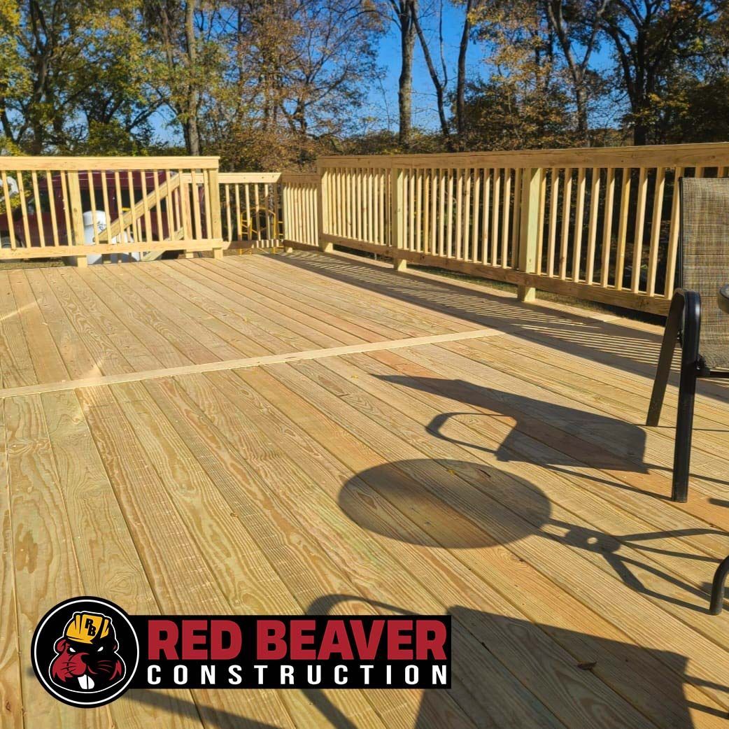 A beautifully finished wooden deck by Red Beaver Construction with smooth planks and a modern design.