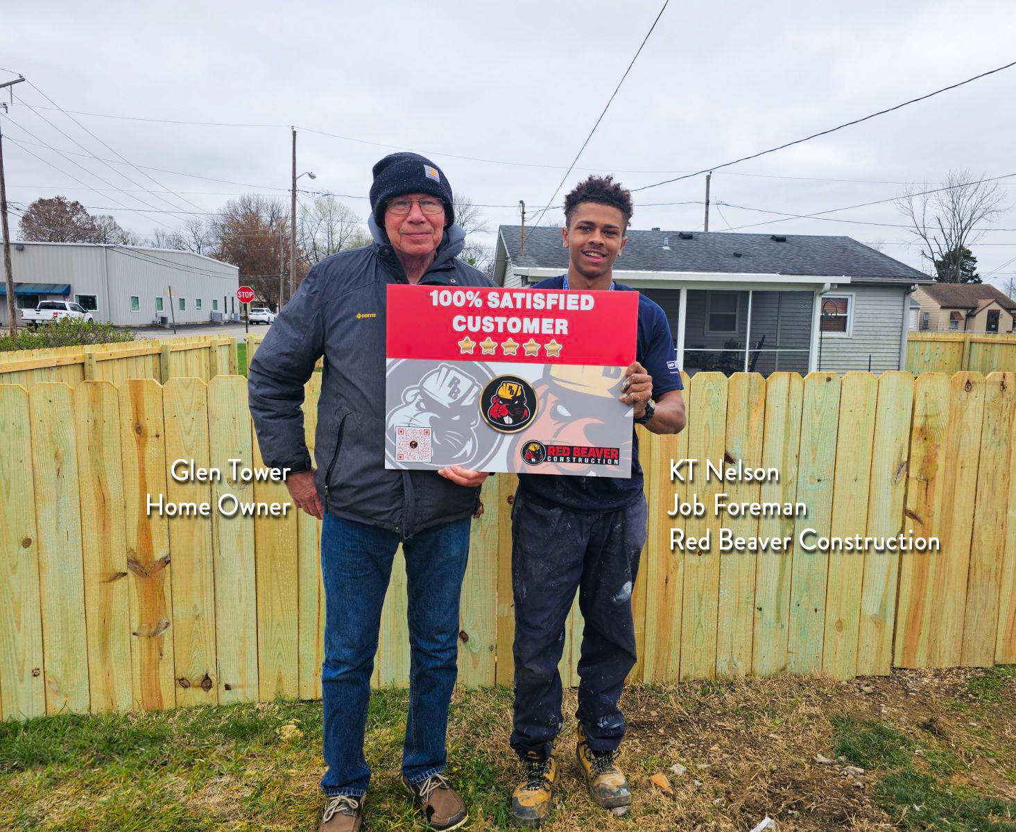 Red Beaver Construction team member standing next to a satisfied customer after completing a fencing project