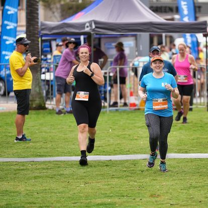 Two Women Running With Black And Blue Shirt — Run Fest in Port Macquarie, NSW