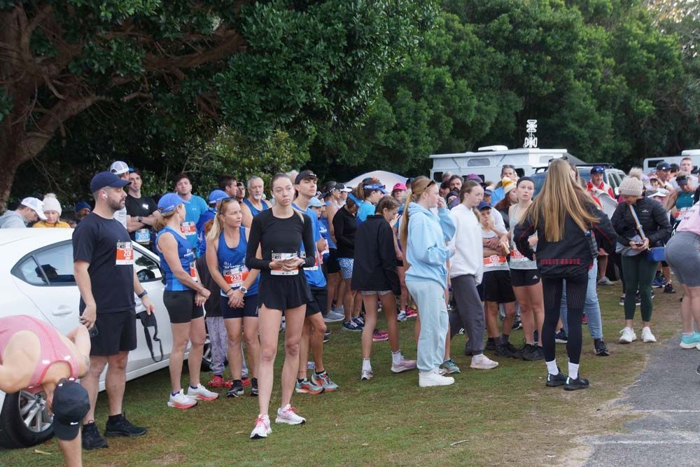 A Large Group Of People Are Standing In A Parking Lot — Run Fest in Port Macquarie, NSW