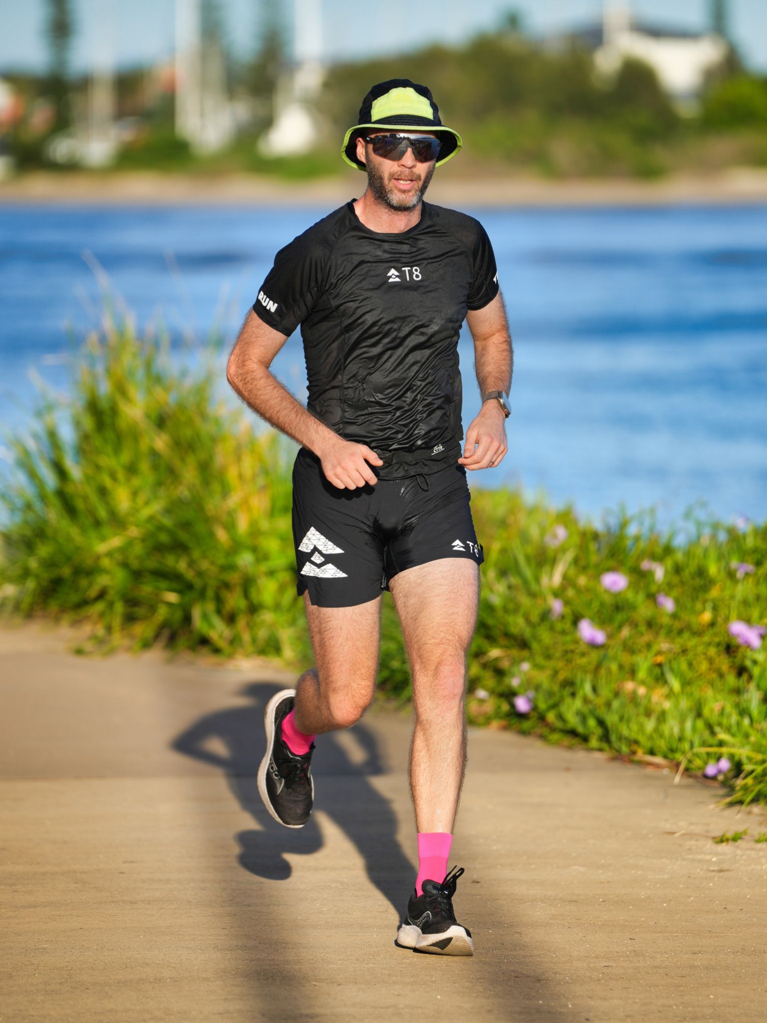 A Man And A Woman Are Running Together Down A Brick Walkway — Run Fest in Forster - Tuncurry, NSW