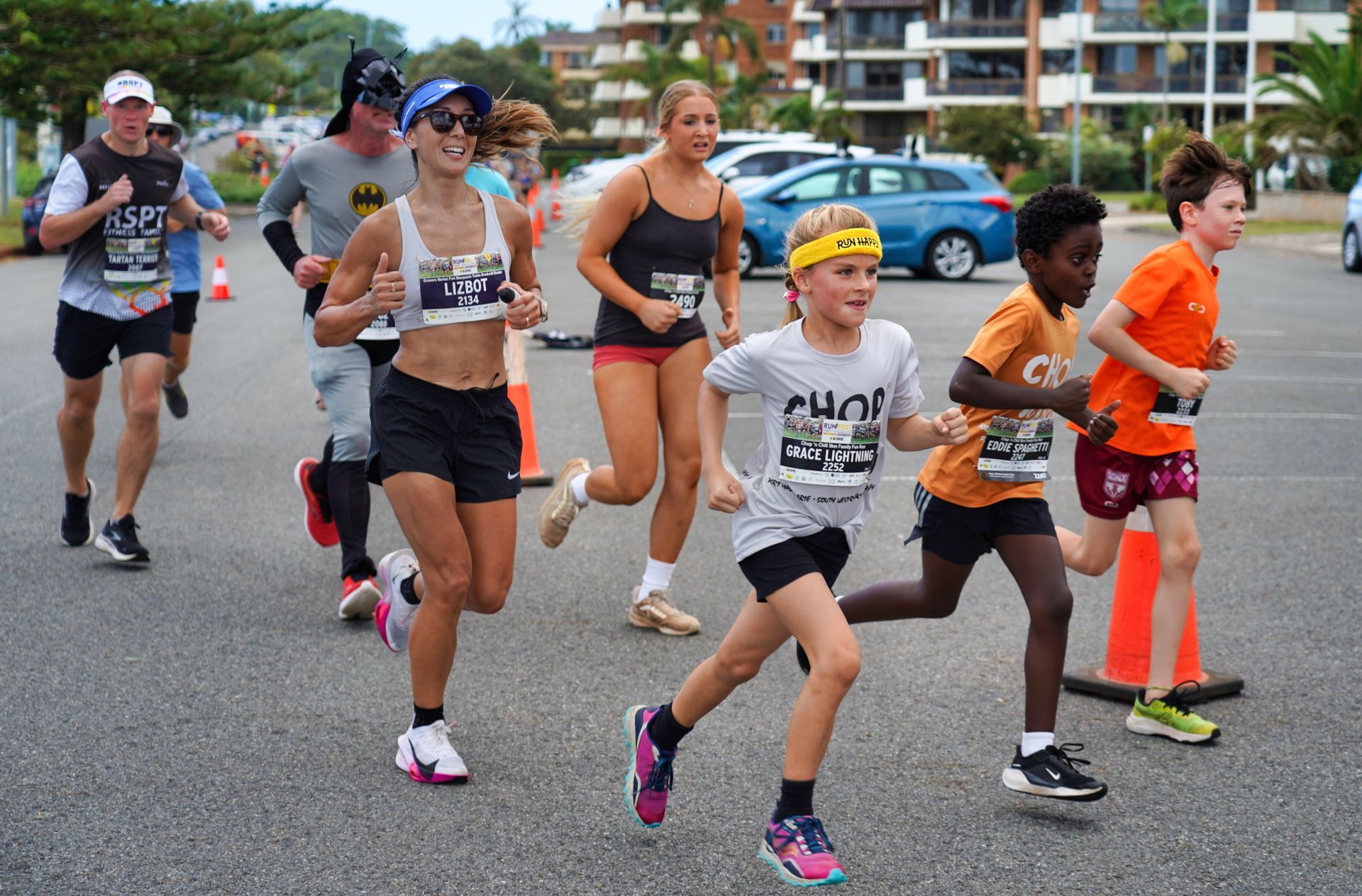 A Man And A Woman Are Running Down A Street Surrounded By Traffic Cones — Run Fest in Port Macquarie, NSW
