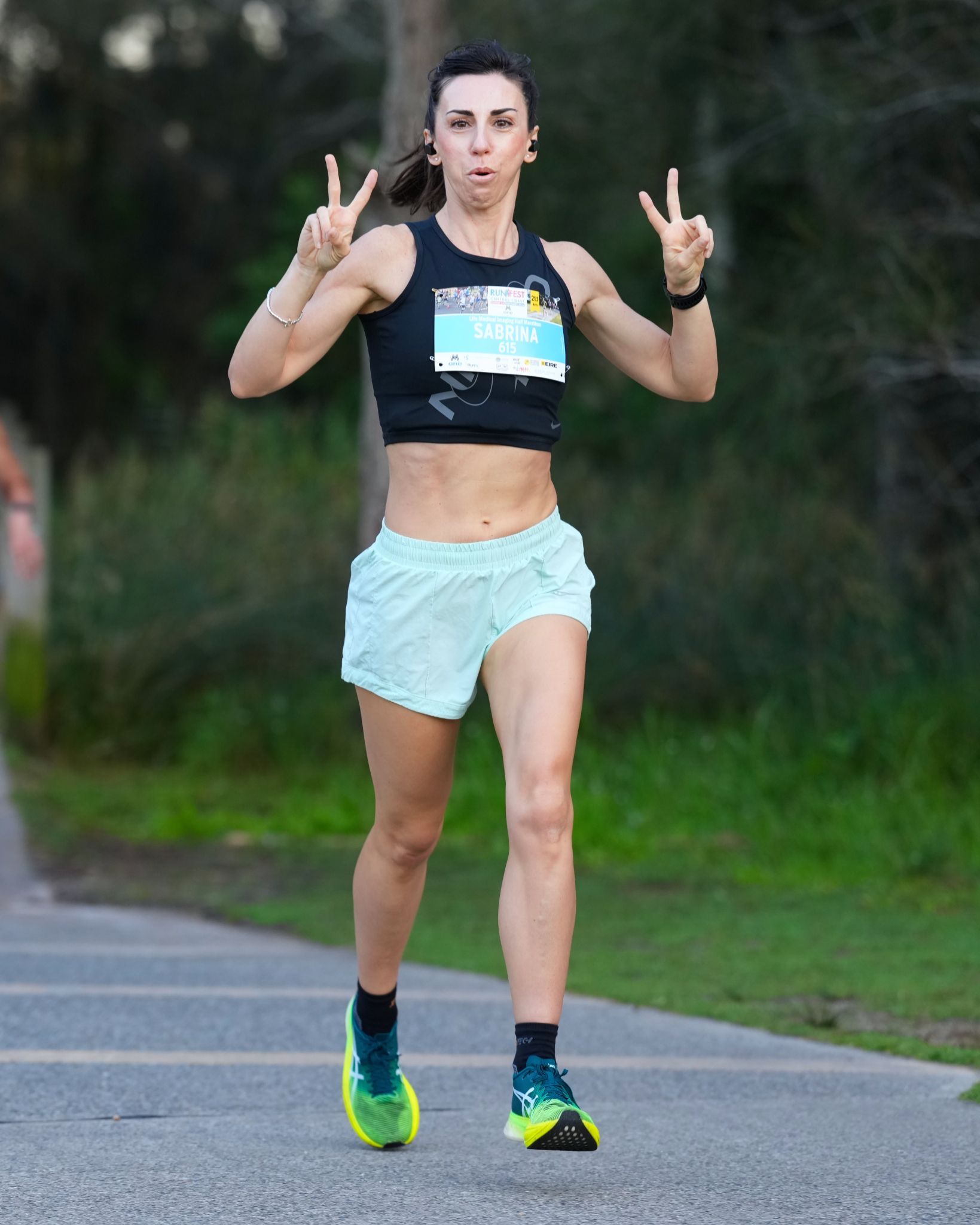 A Woman Is Running A Marathon On A Path In A Park With Number 5026 — Run Fest in Central Coast, NSW