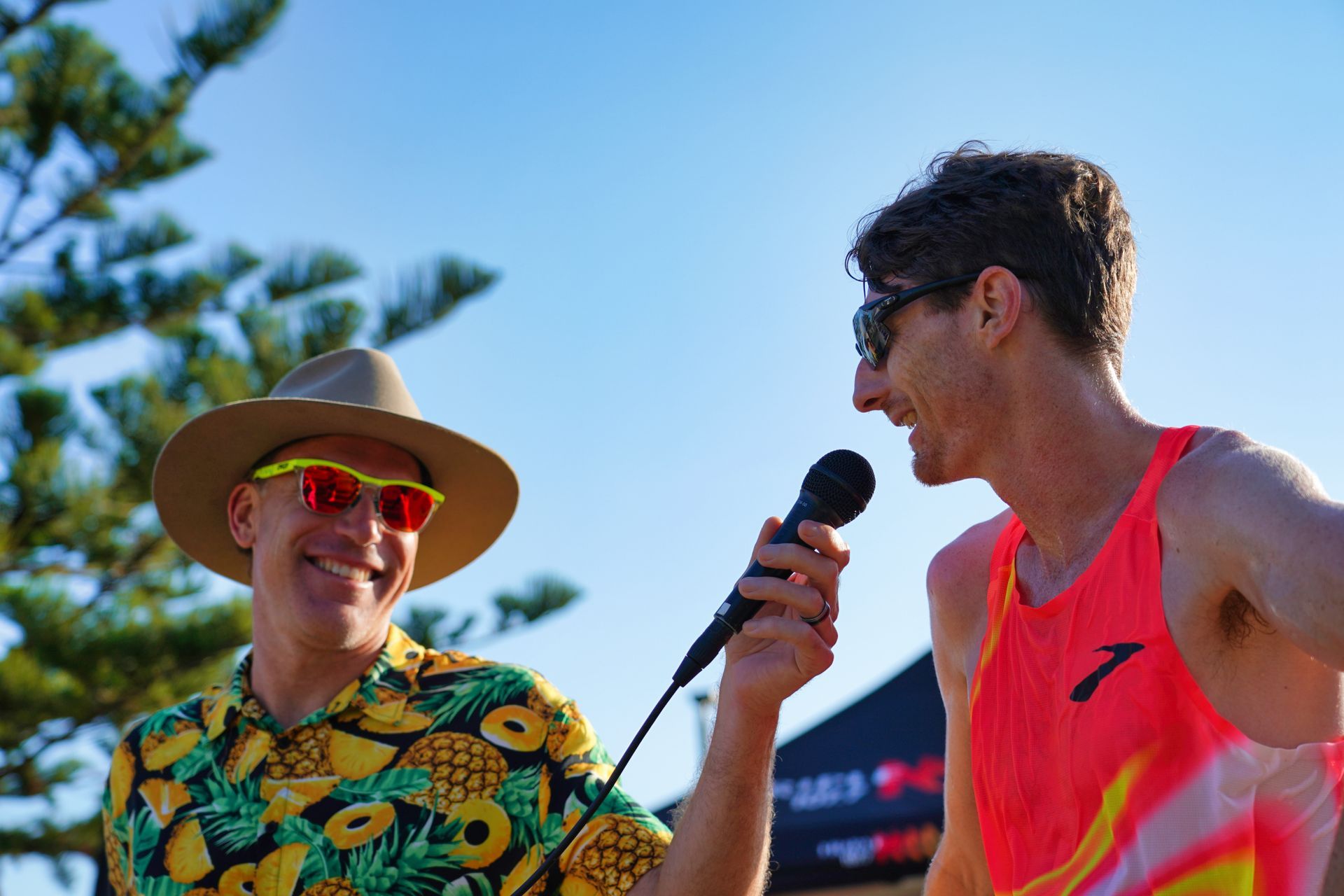 A Group Of People Are Standing On A Stage Holding A Trophy — Run Fest in Central Coast, NSW