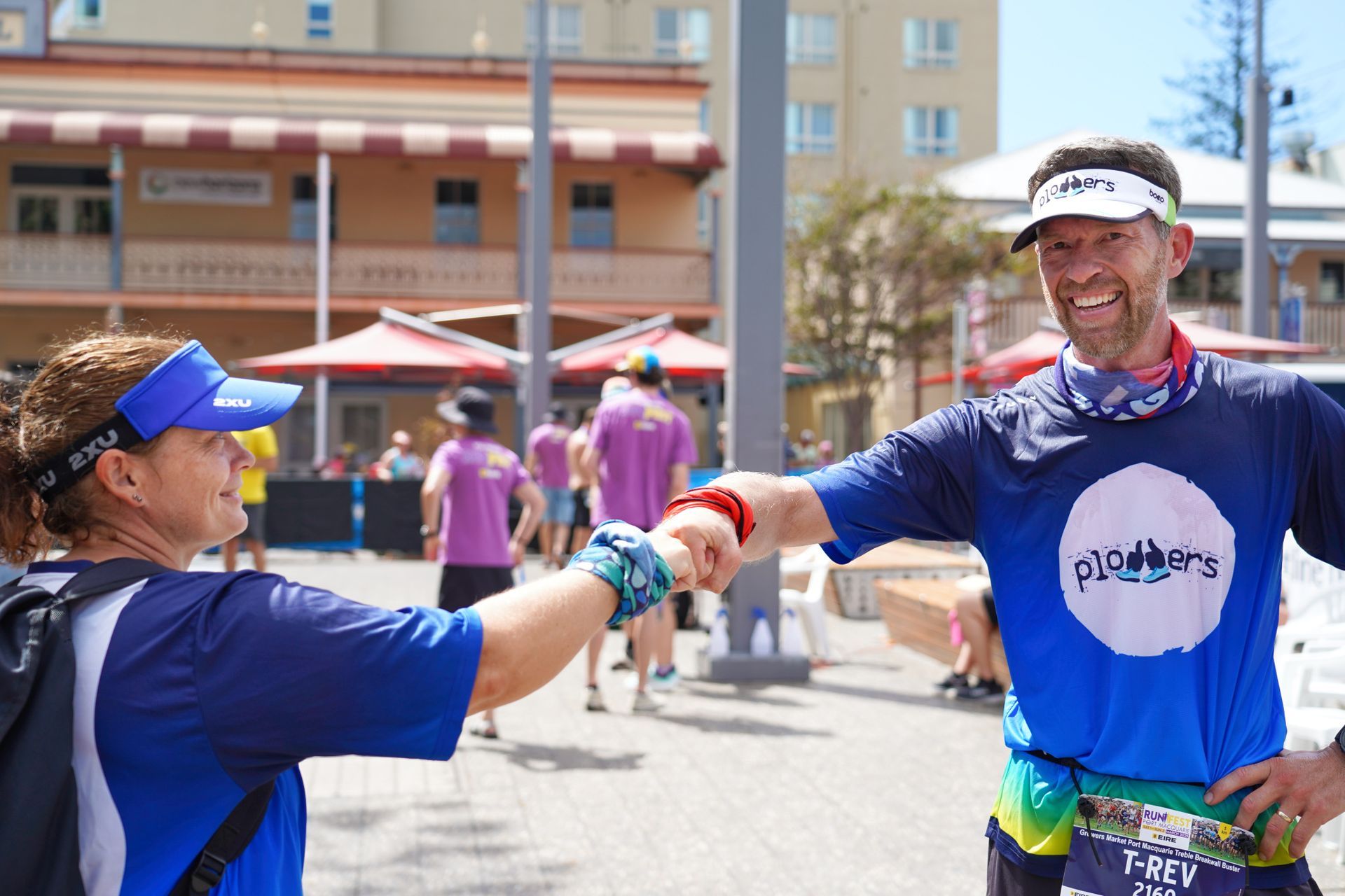 A Group Of Women Wearing Purple Shirts Are Standing Next To Each Other Holding Cups — Run Fest in Port Macquarie, NSW