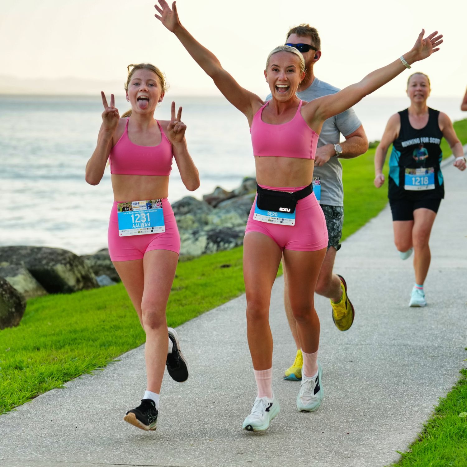 Two People Standing in Front of A Banner that Says Coastline — Run Fest in South West Rocks, NSW