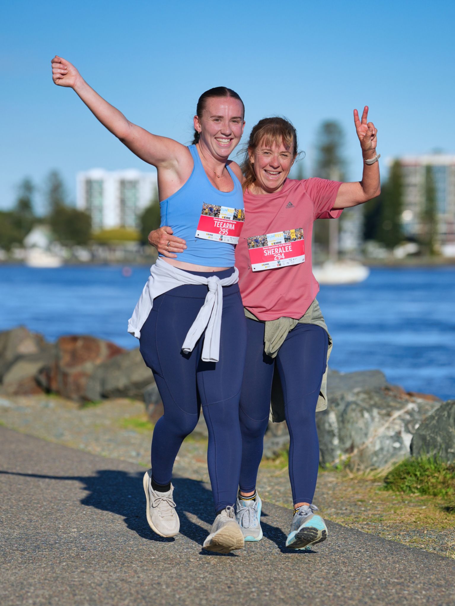 A Man In A Green Shirt Is Running On A Sidewalk — Run Fest in Forster - Tuncurry, NSW