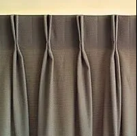 Brown Pleated Curtains Hanging Closed Over a Window — NT Blinds in Yarrawonga, NT