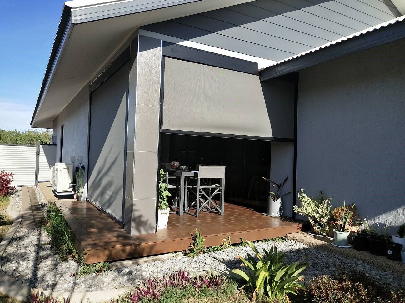 Two Closed, Tan Roll-up Doors on a Corrugated Metal Building — NT Blinds in Nightcliff, NT