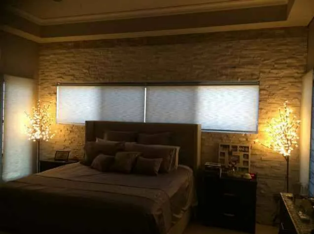 Dimly Lit Bedroom With a Bed — NT Blinds in Yarrawonga, NT