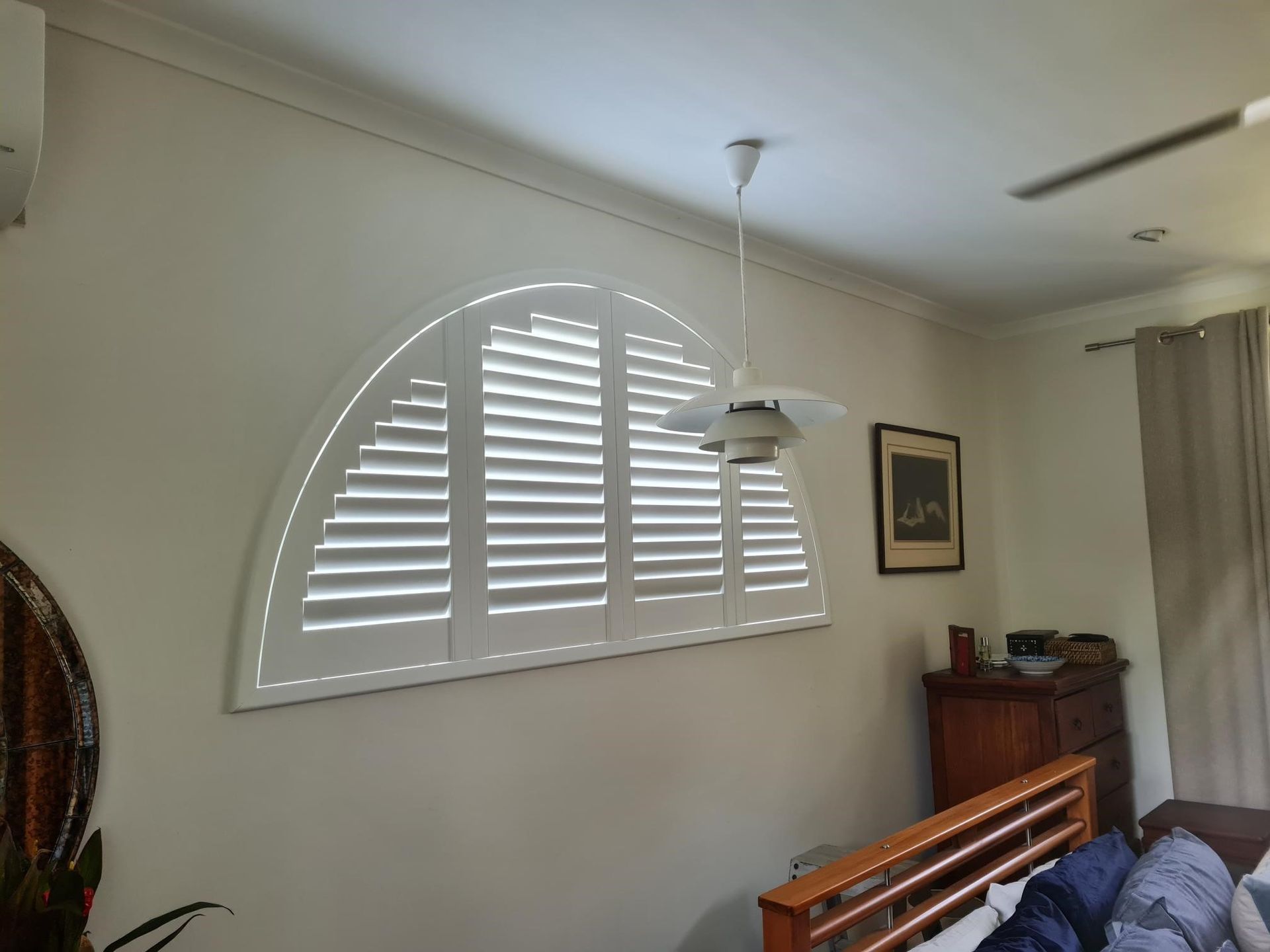 Black Louvered Shutters Over Windows in a Modern Beige Exterior — NT Blinds in Yarrawonga, NT