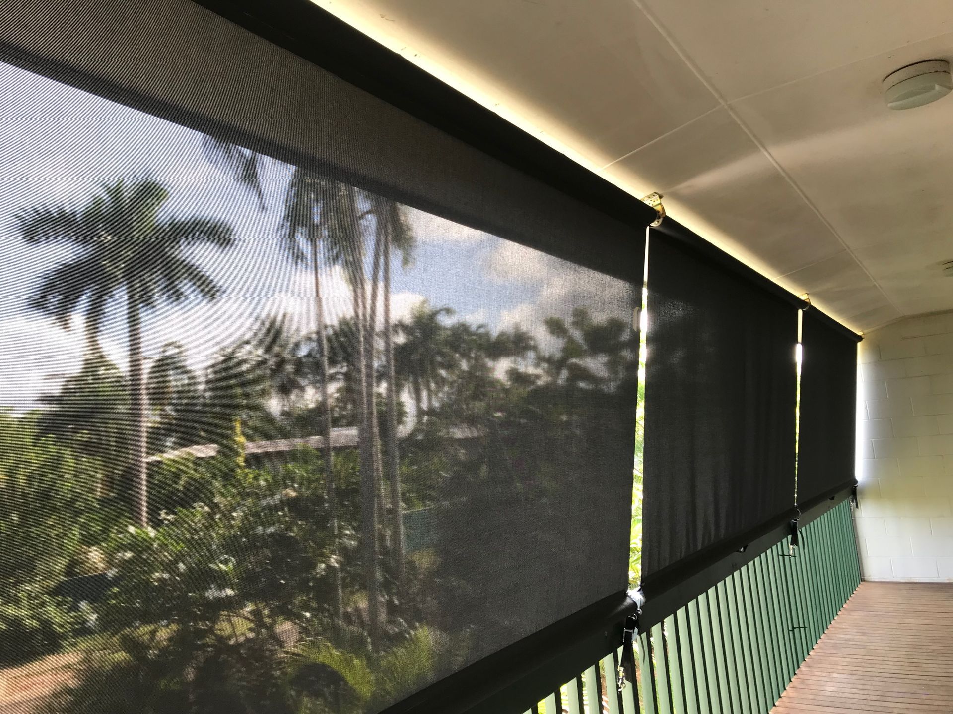 Building Corner With Transparent Rolling Shutters — NT Blinds in Darwin City, NT