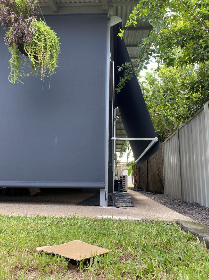 Dark gray building with a black awning extended, narrow walkway  — NT Blinds in Nightcliff, NT