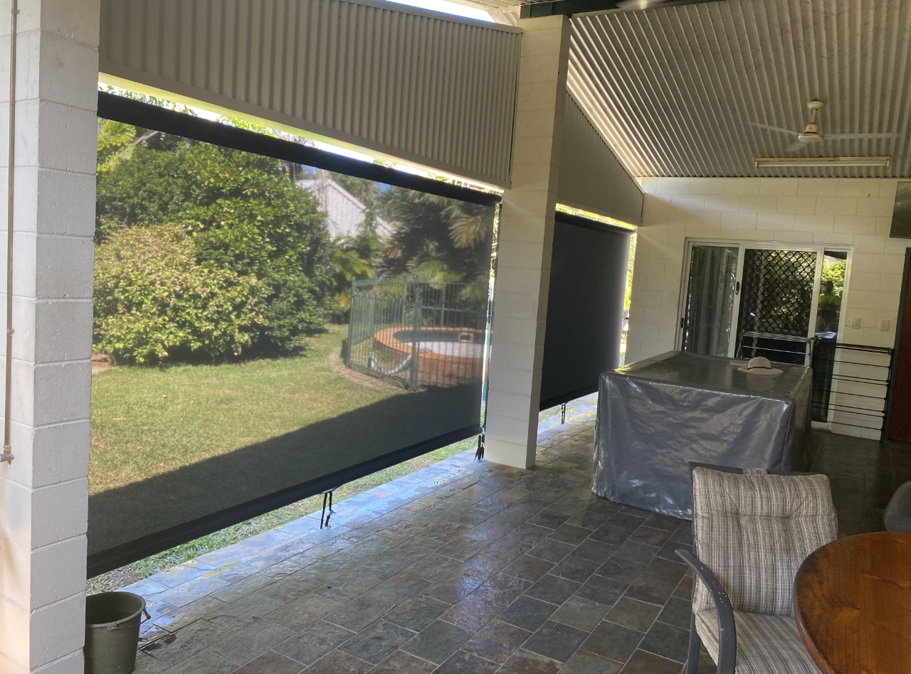 Person installing a white window blind, hands holding the top, near a window frame  — NT Blinds in Yarrawonga, NT