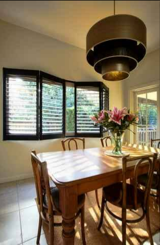 Dining Room With a Wooden Table — NT Blinds in Yarrawonga, NT