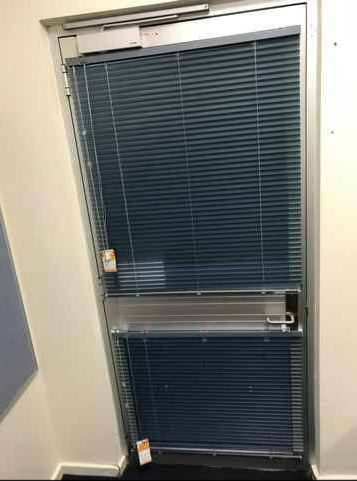 Closed Glass Door With Dark Blue Blinds — NT Blinds in Yarrawonga, NT