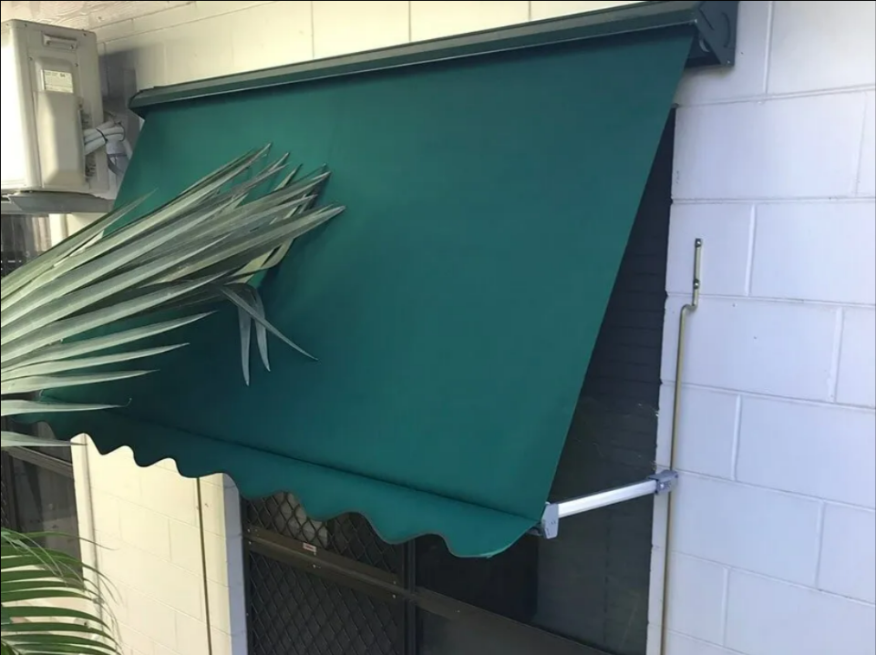 Green Awning Over a Small Window on a Tiled Exterior Wall — NT Blinds in Yarrawonga, NT