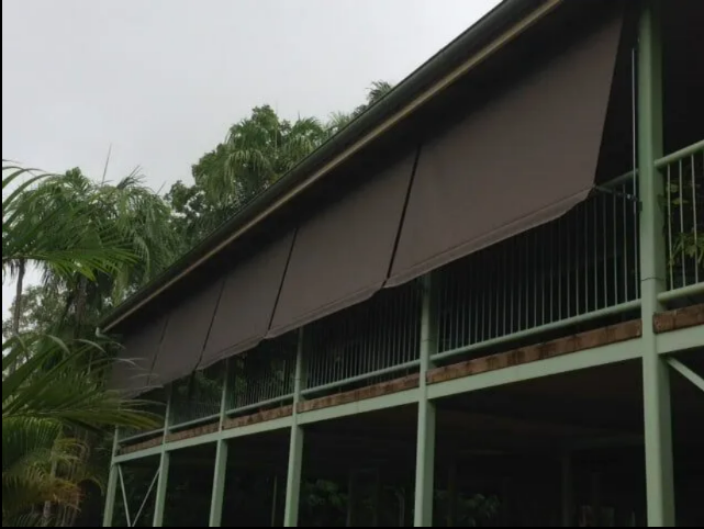 Two-story House With Dark Awnings and Green Railings — NT Blinds in Yarrawonga, NT