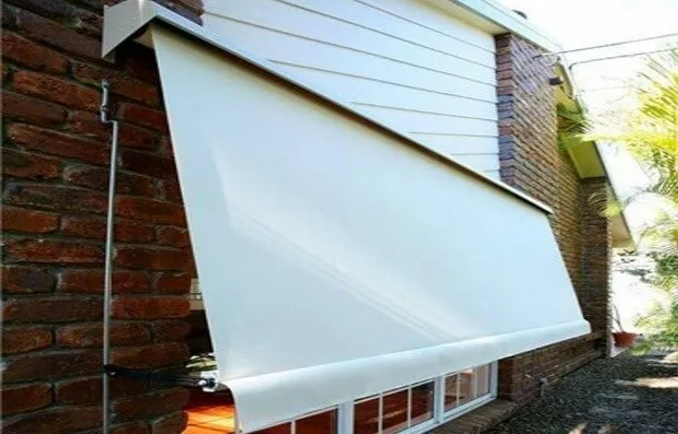 White Retractable Awning Extended Over a Brick House Exterior — NT Blinds in Yarrawonga, NT