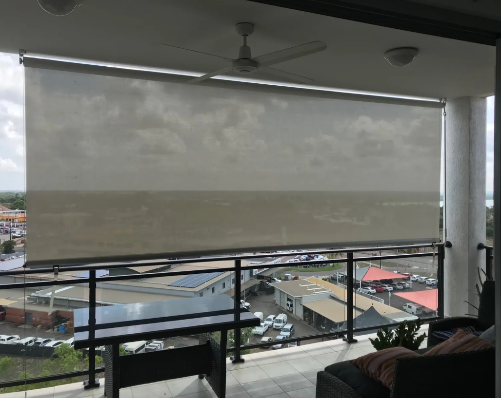 Balcony With a Rolled-down Shade Overlooking a Rainy Marina and Cityscape — NT Blinds in Yarrawonga, NT