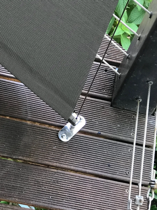 Close-up of a Metal Latch on a Gray Deck Railing Beside Wooden Steps — NT Blinds in Yarrawonga, NT