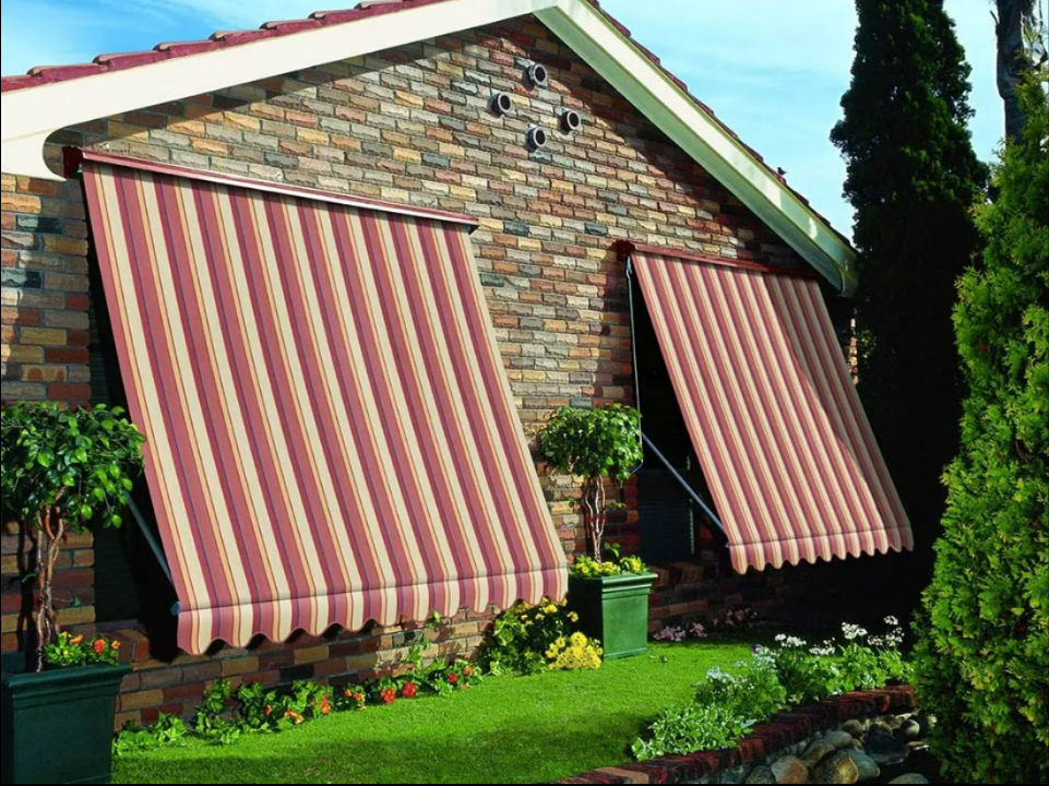Brick House With Two Red-and-cream Striped Window Awnings — NT Blinds in Yarrawonga, NT