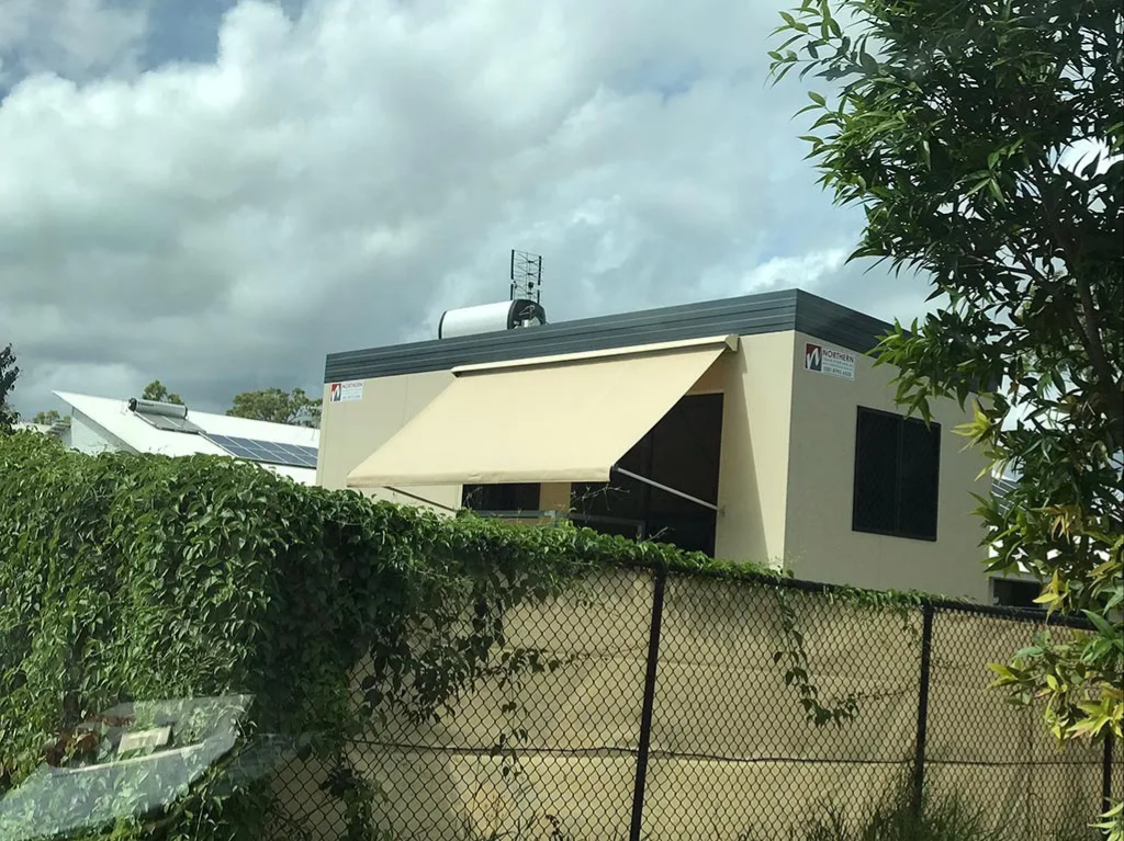 Small Cream-colored House With a Dark Roof Behind a Chain-link Fence — NT Blinds in Yarrawonga, NT