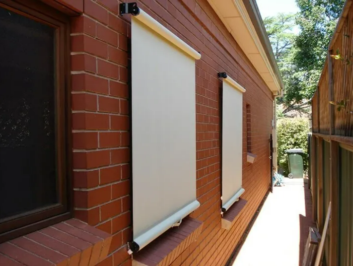 Brick House Exterior With Two Rolled-down — NT Blinds in Yarrawonga, NT