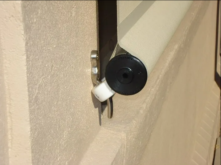 White Latch Attached to a Beige Wall — NT Blinds in Yarrawonga, NT