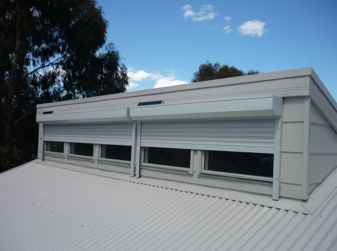 White Rooftop Window Shutters Under a Blue Sky — NT Blinds in Yarrawonga, NT
