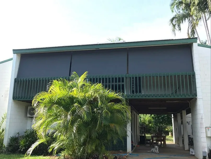 Two-story Building With Green Awnings and a Palm Tree in Front — NT Blinds in Yarrawonga, NT