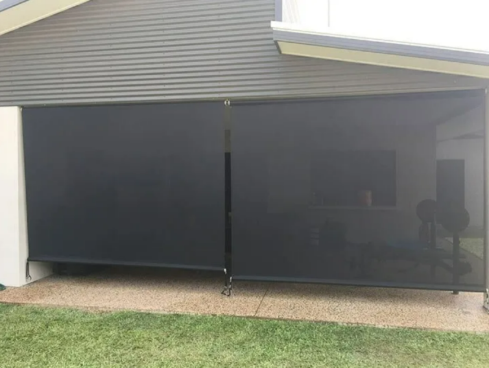 Outdoor Patio With Dark Mesh Sunshade Panels Attached to a House — NT Blinds in Yarrawonga, NT
