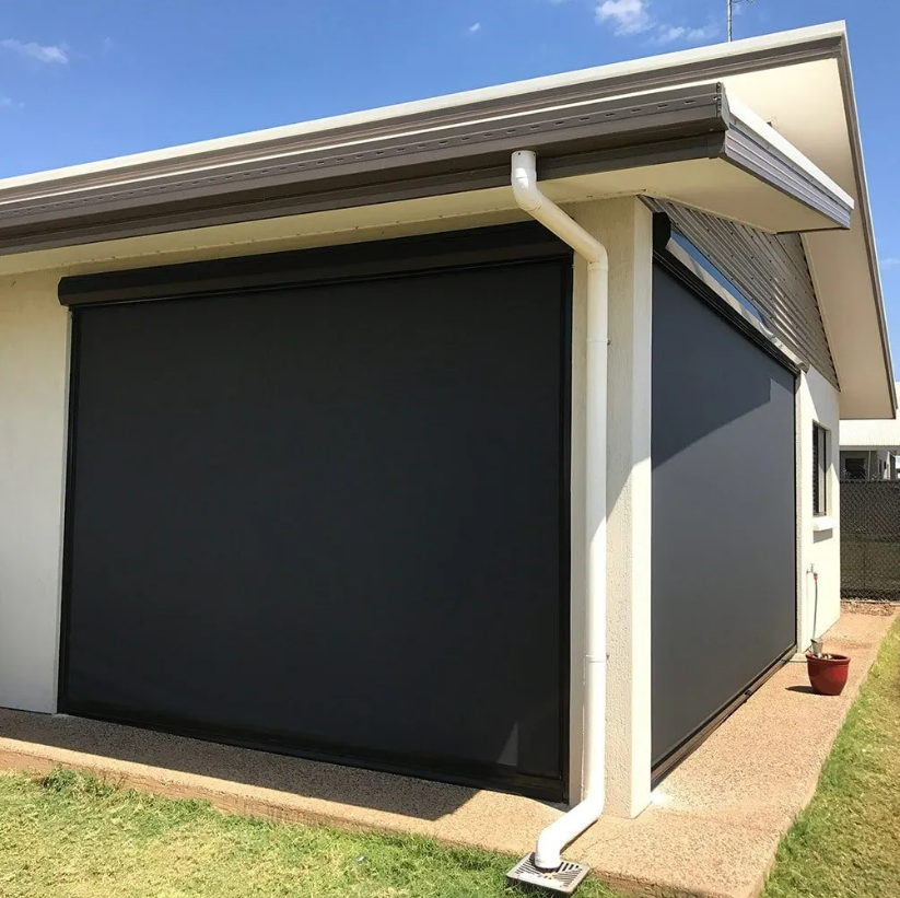 Single-story House Exterior With a Large Black Garage Door — NT Blinds in Yarrawonga, NT