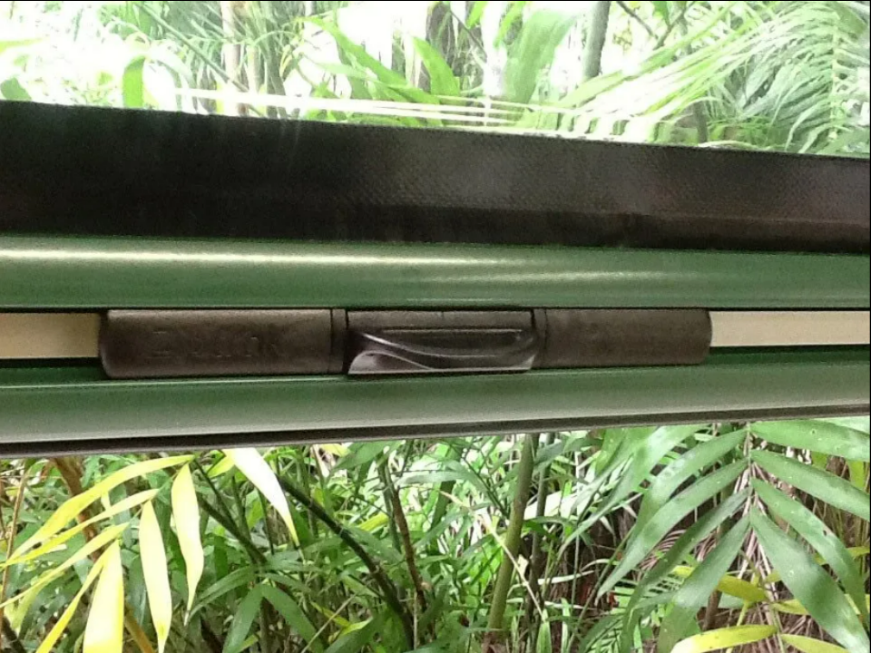 Close-up of a Green Window Blind Slat With a Black Clasp — NT Blinds in Yarrawonga, NT