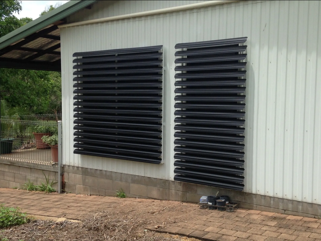 White Building Wall With Two Large Black Louvered Vents — NT Blinds in Yarrawonga, NT